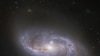 资料照片：美国宇航局/欧空局哈勃太空望远镜深入宇宙瞥见的无数的臂状结构，这些结构横跨这个被称为NGC 2608的螺旋星系。(美国宇航局提供)