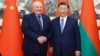 资料照片: 2023年12月4日中国国家主席习近平(右)在北京与来访的白俄罗斯总统卢卡申科握手