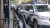 (FILE) Police cars are parked as policemen stand guard in the southern Chinese city of Guangzhou, Jan. 29, 2016.