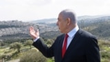 资料照片：以色列总理内塔尼亚胡以西岸犹太人定居点为背景发表讲话。