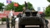 资料照片: 2024年7月24日万象第57届东盟外长会议期间装甲车旁的老挝军人