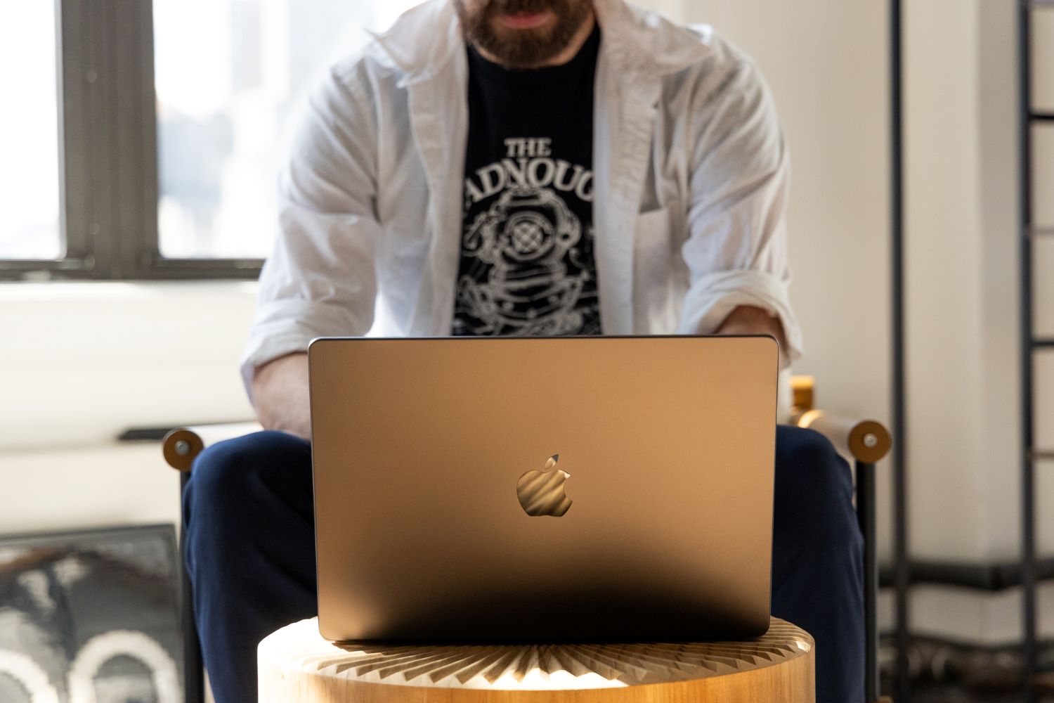 Apple Macbook Pro 2024 with a person sitting behind it and typing