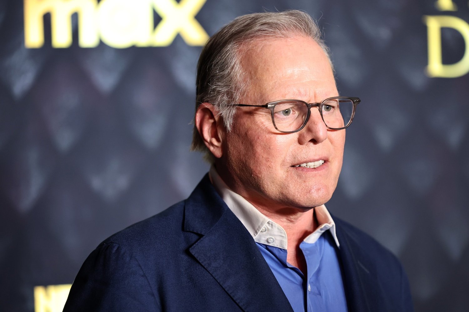 David Zaslav standing in front of a sign reading Max