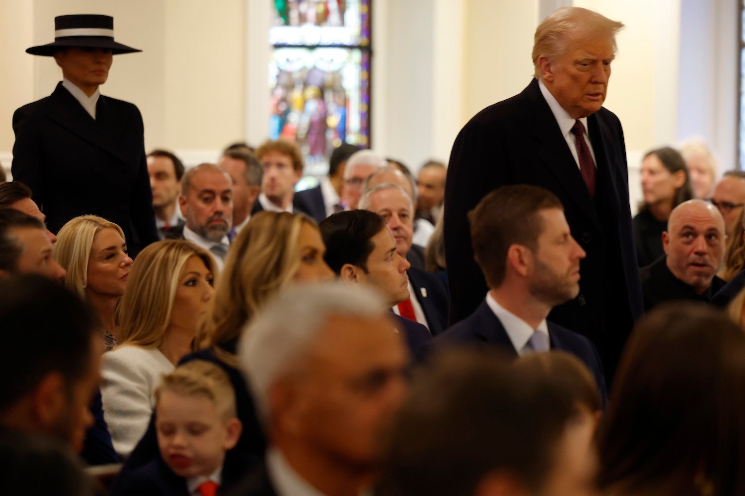 Donald Trump arrives at St. John's Church as Big Tech oligarchs sit behind him and podcaster Joe Rogan looks on nearby.