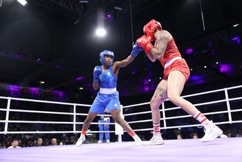 Refugee athlete Cindy Ngamba (left) is set to become the first ever medalist for the Refugee Olympic Team.