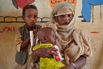 Children in Sudan receive a peanut-based paste for treatment of malnutrition.