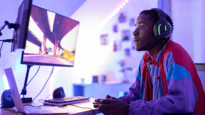 young Black man playing video games