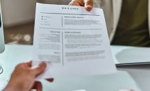 a resume being handed from one person to another