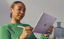 A person holding an iPad Air and Apple Pencil