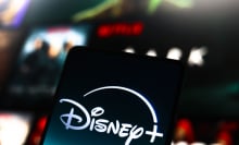 The Disney Plus logo is displayed on a smartphone screen