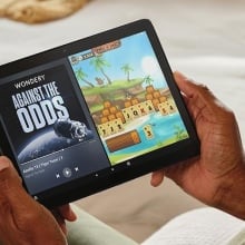 Person using an Amazon Fire HD 10 tablet