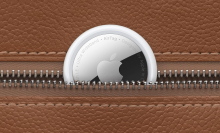 An AirTag peeking out of a leather wallet