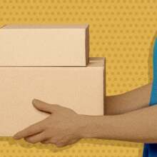 A person holding cardboard boxes.