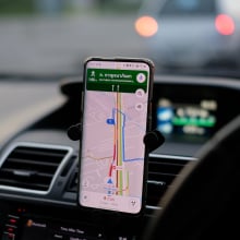 Google Maps on a phone that is attached to a car dashboard.