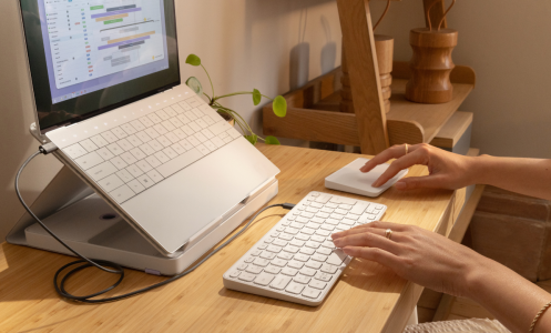 desk set up with casa pop-up stand, keyboard, and trackpad