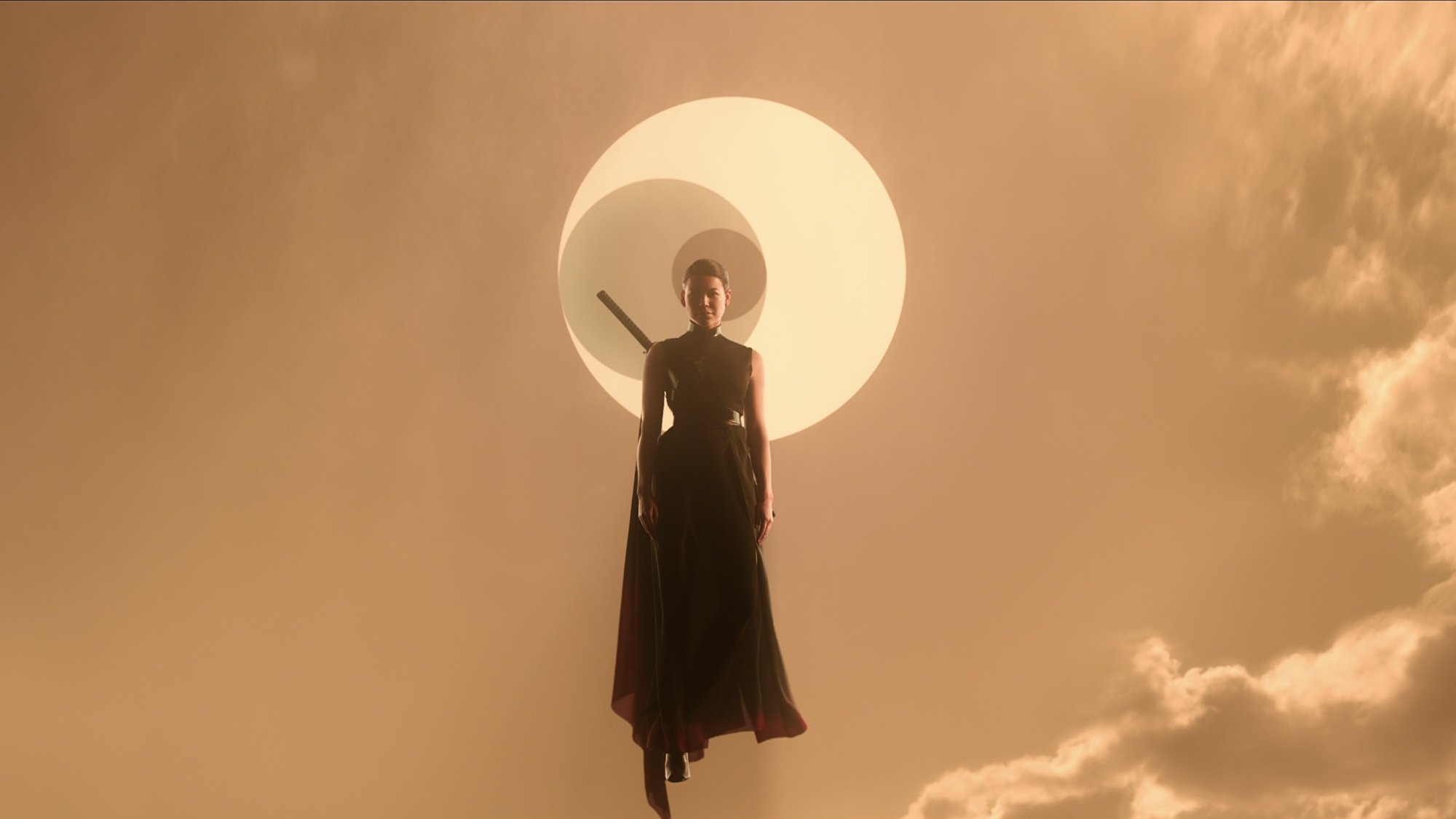 A woman with a sword strapped to her back floats through an orange sky against a symbol of three interlocking symbols.
