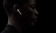 Side profile of a man wearing Apple AirPods 