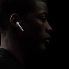 Side profile of a man wearing Apple AirPods 