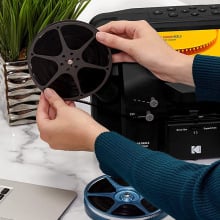 person using Kodak Reels film digitizer