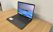 An HP Chromebook sitting on a wooden table