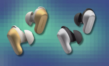 Gold and silver Bose QuietComfort Earbuds on colorful abstract background