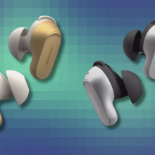 Gold and silver Bose QuietComfort Earbuds on colorful abstract background