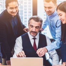 Group of multiethnic business people training by executive senior boss in modern office with laptop computer.