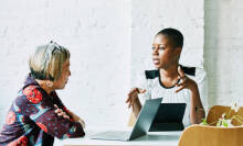 Two women practicing new language.