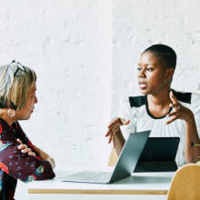 Two women practicing new language.