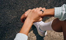 a close-up of a samsung galaxy ring on the finger of a resting runner