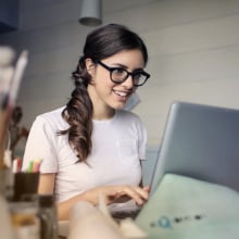 Woman working on a laptop.