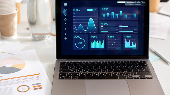 laptop displaying data graphics