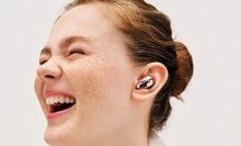 Woman with freckles smiling while wearing the Samsung Galaxy Buds Live in one ear.