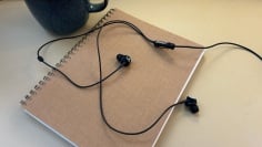 marshall mode headphones resting on a notebook next to a mug of tea