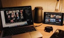 a macbook and ipad sit open on a desk