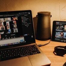 a macbook and ipad sit open on a desk