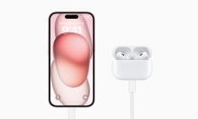 pink iphone 15 plugged into usb c airpods pro