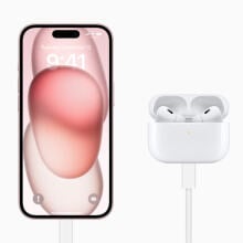 pink iphone 15 plugged into usb c airpods pro