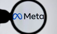 meta logo seen through a magnifying glass