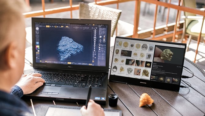 Person using a Desklab Portable Touchscreen Monitor to work.