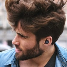 JBL Live Free NC+ earbuds in a man's ear while his head is turned to the side