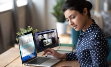 Person using laptop with external monitor attached