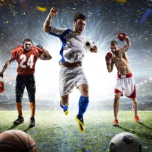 three male athletes on field with various sports equipment