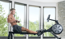 Shirtless man using NordicTrack Rower