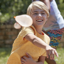 child throwing water balloon