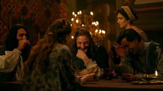 In "The Decameron" a group of nobles giggle at a dinner table.