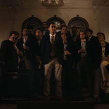 The cast of "The Line" walk down the stairs in a frat house.