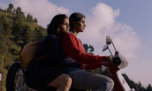 A mother and daughter ride together on a scooter.