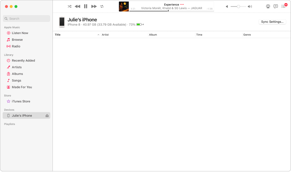 The Music window with a device (Julie’s iPhone) in the sidebar. The Sync Settings button in the top-right corner opens the Finder.