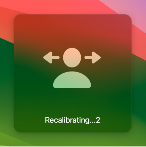 The on-screen countdown for head pointer recalibration, showing "Recalibrating…2."